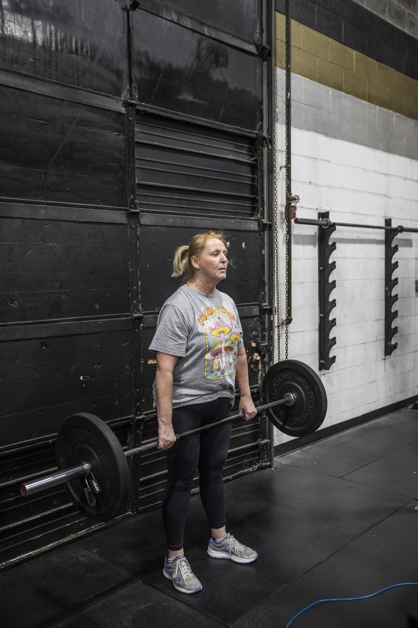 A member setting up a deadlift on the gym floor